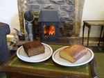 Two cakes in front of a fireplace